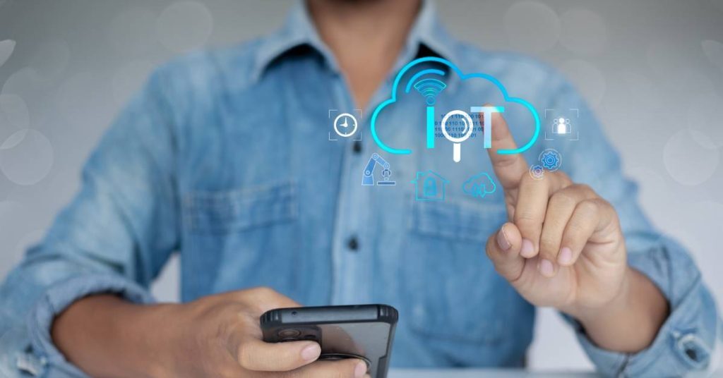 An employee uses an IoT app on their mobile phone.