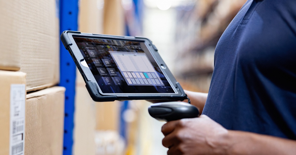 warehouse-worker-holding-tablet-scanning-inventory-boxes