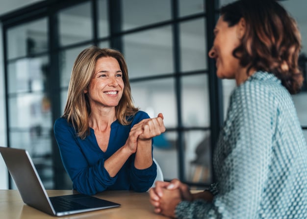 A financial services professional meets with a client in an office setting.