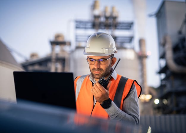 Utility engineer using laptop at site