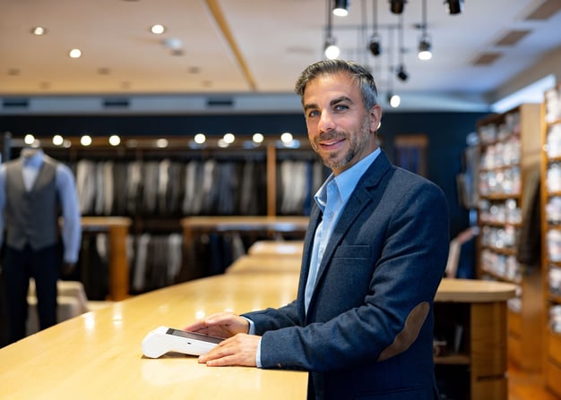 A retail clothing employee at the counter.