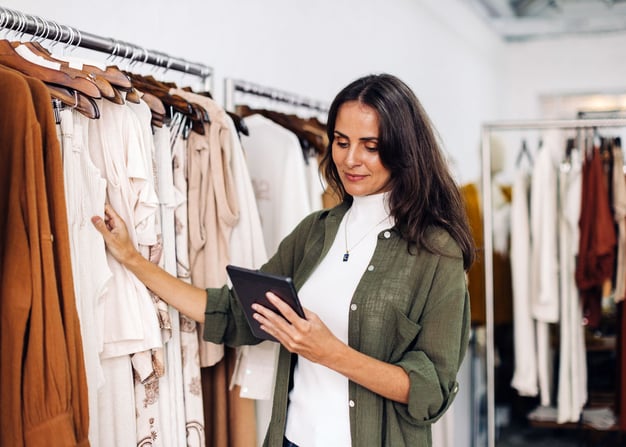 A retail store manager uses a tablet.