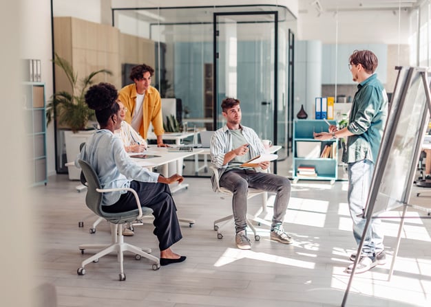 A software engineering team brainstorms together inside a modern office setting.