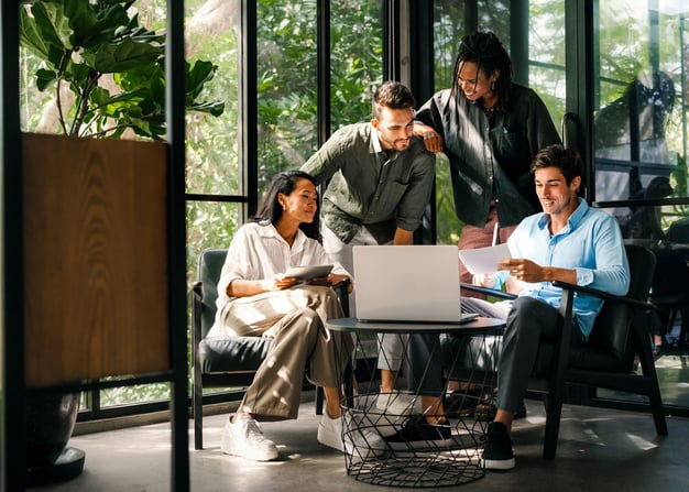 A nearshore software engineering team collaborates on a project in an exotic office setting.