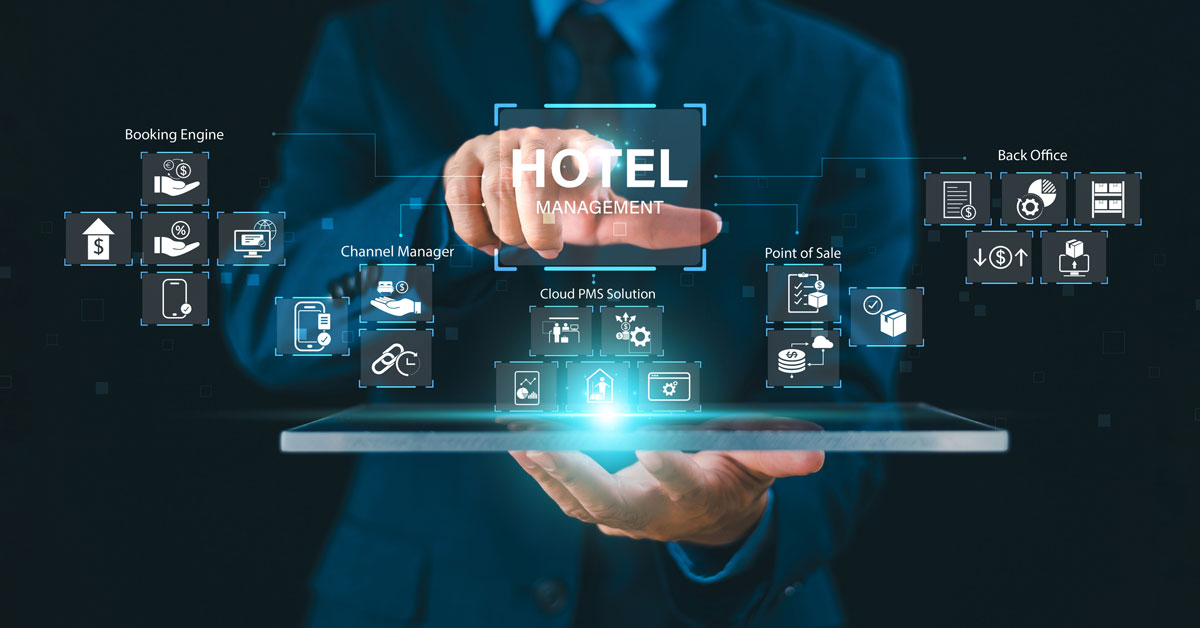 A closeup on a male hand holding a laptop with a digitized depiction of hotel management software.